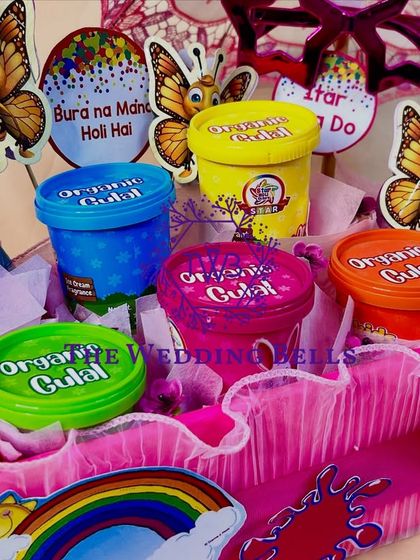 A close-up of the fun elements in our Holi platter, including quirky props and colorful organic gulal cups.