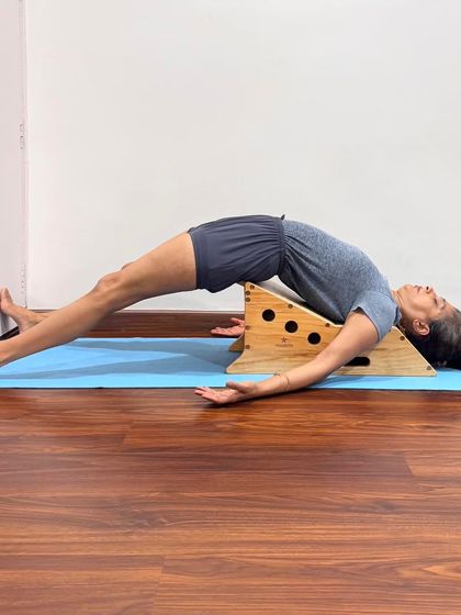 Setu Bandha Sarvangasana on a Simhasana Box. This asana establishes a healthy connection between body and mind. The brain remains tranquil while the expanded chest awakens the heart, allowing the process of purification to begin.