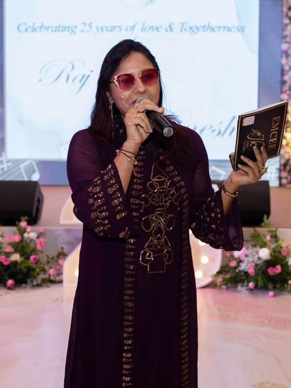 On stage, ready to host a 25th anniversary party. My job is to narrate the beautiful journey of the couple and celebrate it with all their loved ones.