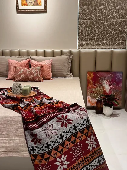 We styled this bed with a colorful throw and abstract art to add personality to the neutral room. It shows how accessories can completely change the vibe of a space.