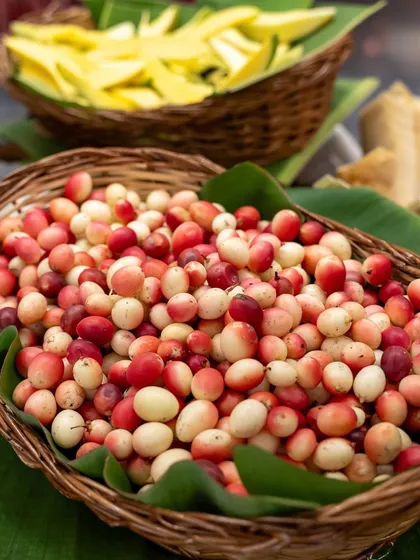 Baskets overflowing with colourful karonda berries and sliced raw mangoes. This display is not just food, but a colourful and interactive experience for everyone.