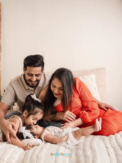 A candid moment of the whole family together on a beautifully styled bed. These lifestyle shots are relaxed and fun, allowing your family's personality to shine through.