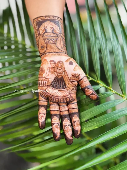 A detailed look at the right hand from a Karwa Chauth set, showing a woman with her puja thali and a peacock design on the wrist.