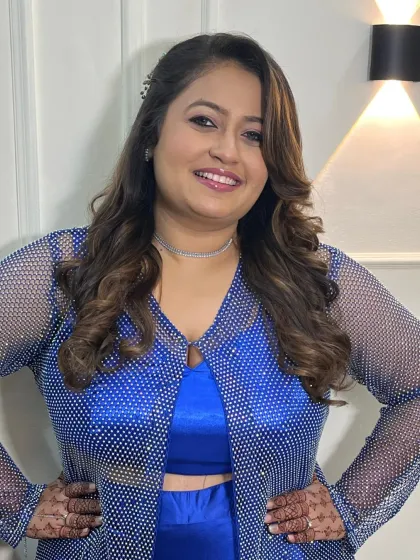 A full-length shot showing the complete party-ready look. The makeup is designed to complement the sparkling outfit.