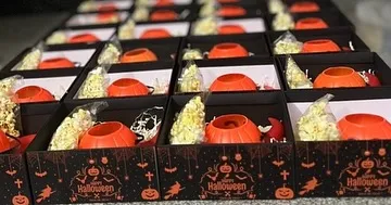 A look inside our custom Halloween boxes. We filled them with treats like popcorn in pumpkin buckets to create a fun and memorable unboxing experience.