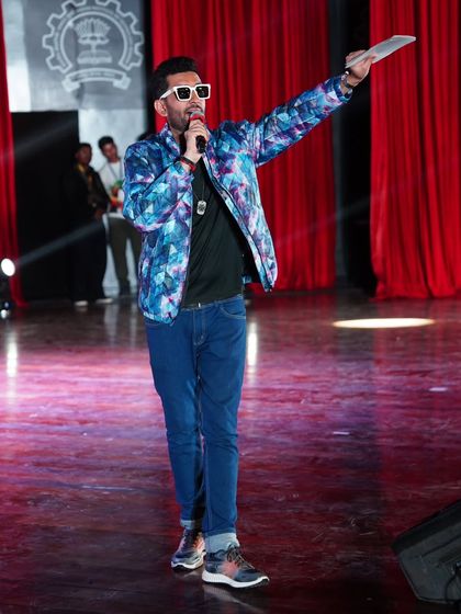 Pointing to the next act, keeping the show moving. Smooth transitions and high energy are my signatures as a college fest anchor.