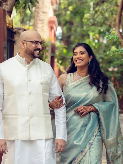 A happy couple takes a stroll down a leafy lane, a perfect example of a casual and relaxed pre-wedding photoshoot.
