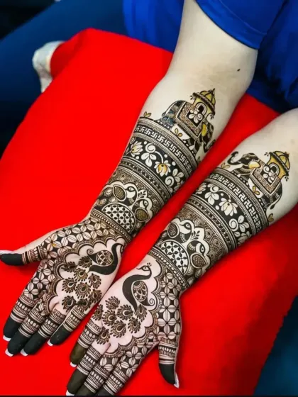 This design combines auspicious symbols like the swastika with traditional motifs of peacocks and elephants in howdahs.