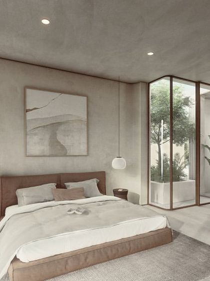 In our Pavilions in the Fields project, this bedroom features soft, textured walls and a glass-enclosed courtyard. The design creates a light, experiential feel, where the boundary between the interior and the private green space is beautifully blurred.