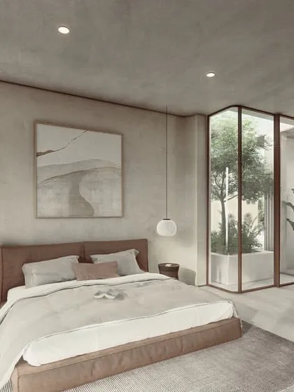 In our Pavilions in the Fields project, this bedroom features soft, textured walls and a glass-enclosed courtyard. The design creates a light, experiential feel, where the boundary between the interior and the private green space is beautifully blurred.