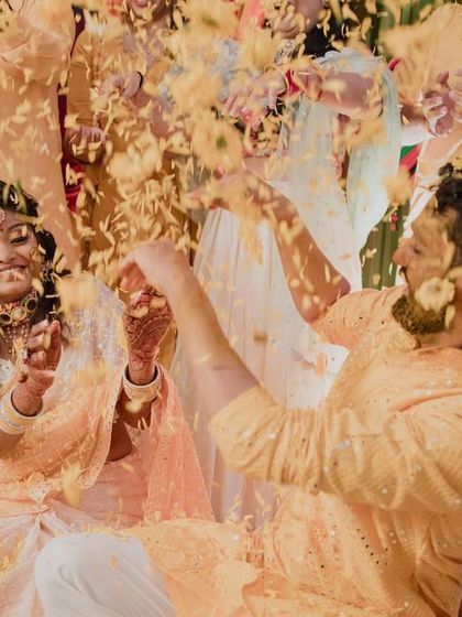 A moment of pure joy during the Haldi. Our waterproof and long-lasting makeup ensures the bride looks perfect even during the flower shower.