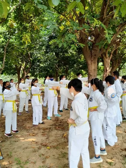 I am demonstrating the correct hand position for a technique to a group of students. Direct, hands on correction is a big part of my teaching method.