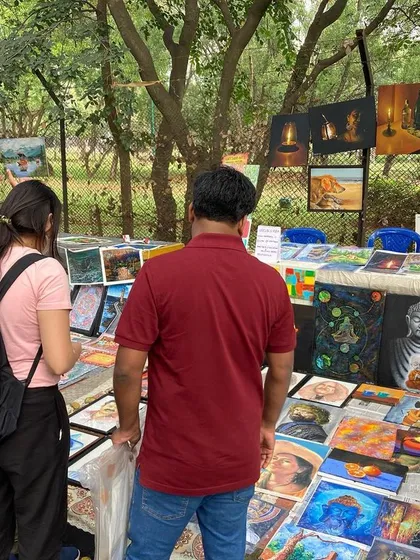 Explaining the different styles and stories of my paintings to interested visitors.