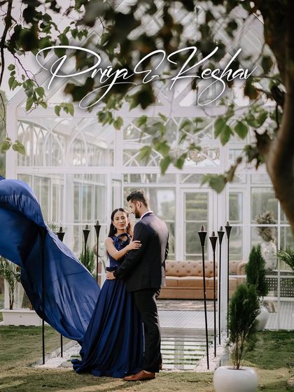 Capturing the drama of the flowing gown against the beautiful glasshouse, this shot is pure cinematic romance.