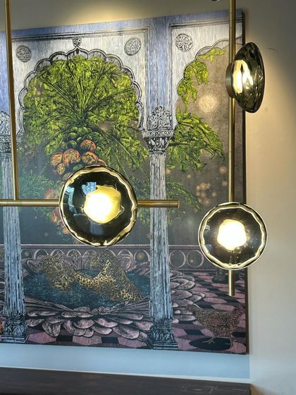 A close-up of the Ceto chandelier, showing the detail of the mouth-blown glass shades with their unique, rippled edges.