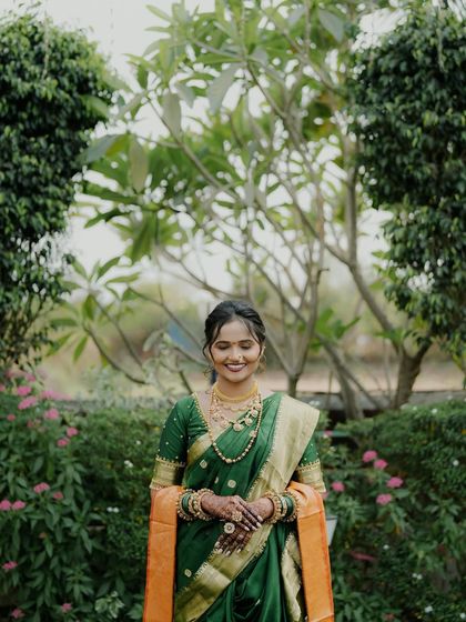 A beautiful wide shot of the bride in a garden, her mehendi adding to her overall elegance.