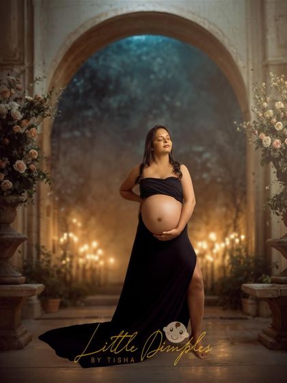 Creating a magical, candlelit scene in the studio. This portrait in a black gown has a dramatic and romantic feel, perfect for a fine art maternity photo.