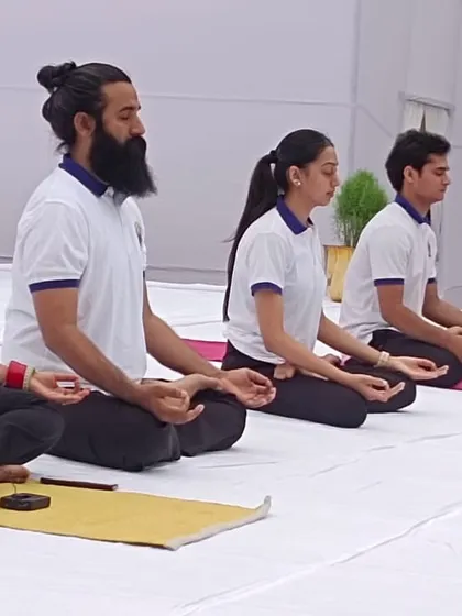 Our instructors lead a meditation session on stage. Their calm and centered presence guides the entire group into a state of deep relaxation and inner peace.