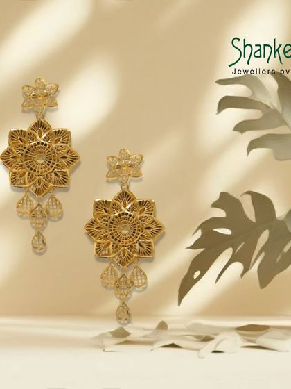 Golden moments from a bygone era. These large, star-shaped floral earrings with delicate drops are a perfect example of our intricate and artistic design capabilities.