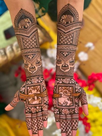 A lovely engagement mehandi design featuring a doli and groom on an elephant. The palms are personalized with the couple's initials "A" and "P".