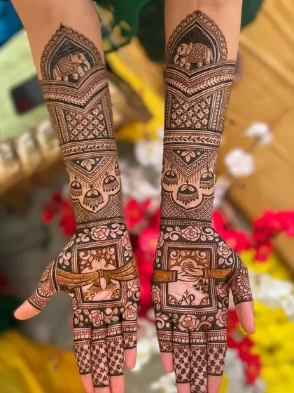 This design features elephant motifs and the couple's initials "AP," surrounded by traditional patterns.
