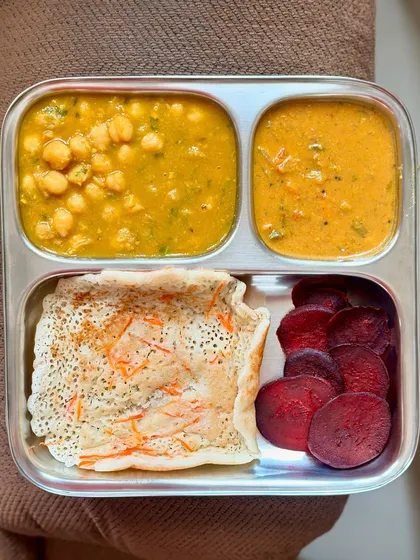 A delicious vegetarian meal of oats dosa, channa masala, sambar, and sliced beetroot. This plate offers a great mix of fiber, protein, and essential micronutrients.