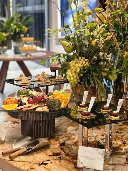 Another view of the grazing table, showcasing the variety of cheeses, fruits, and crackers on offer.