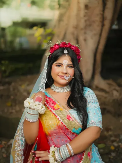 A beautiful portrait of the Radha look. The makeup is soft and devotional, with a floral crown and traditional jewelry completing the theme. This is a great example of cultural and festive makeup artistry.