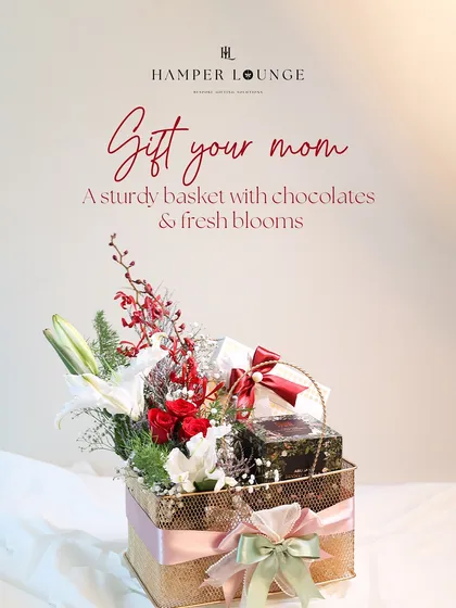 Gift your mom this sturdy and reusable golden basket. I've filled it with gourmet chocolates, luxury treats, and a fresh bouquet of red roses and white lilies, making it a hug in a box.