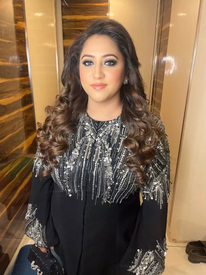 The complete look, pairing the intense smokey eye with soft, voluminous curls for ultimate cocktail party glamour.