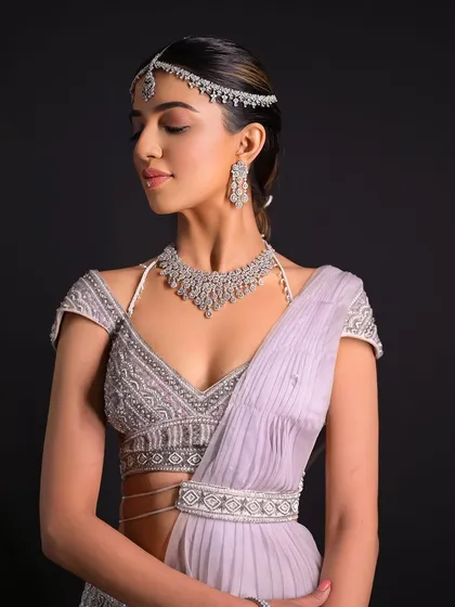 A portrait of the bride, showing the elegance of the simple hairstyle paired with a glamorous outfit.