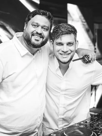 A black and white shot with an event partner, showcasing the collaborative spirit behind every successful gig.