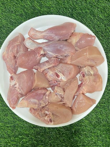 A plate of our Chicken Curry Cut, showing the different pieces included. This is a versatile option for both raw and cooked feeders.