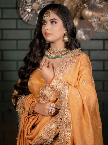 A gorgeous client ready for her event with soft, open waves and a beautiful maang tikka. This look is perfect for a Sangeet or reception.