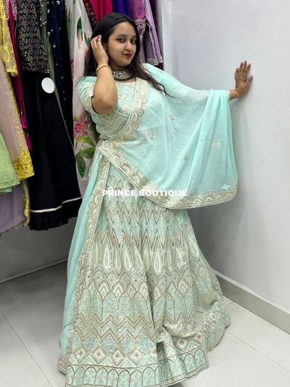 A duplicate of 207, showing the beautiful flare of the light blue lehenga.