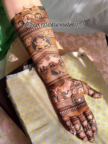 A full arm design showcasing a variety of scenes in bands, including Ganesha, a doli, and elephants.