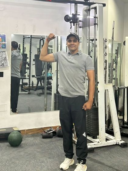 Flexing to show the results of consistent training. Strength is built one rep at a time.