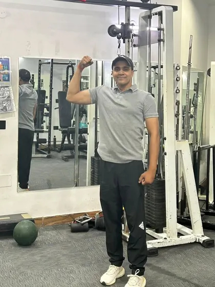 Flexing to show the results of consistent training. Strength is built one rep at a time.