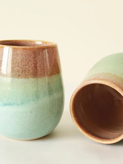 This pair of Pist-a-chio mugs shows how the glaze settles differently on each piece, making them a perfectly imperfect set. They are wheel-thrown for a smooth, rounded shape.