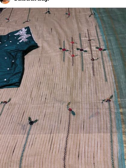 One of my creations worn by a happy client. This saree features delicate floral vines embroidered on a striped cotton base, a simple design for everyday grace.