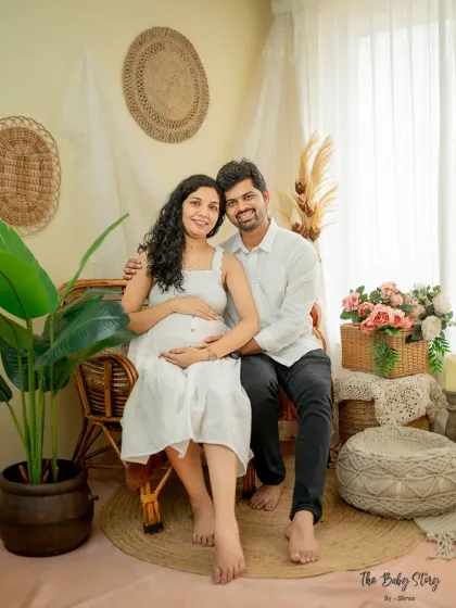 A full-length portrait of the couple in the boho-themed corner of my studio. This shot shows the complete setup, with its natural textures and warm tones creating a cozy atmosphere.