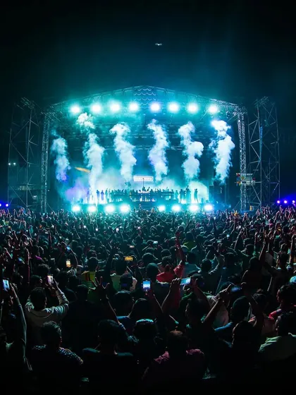 A fish-eye lens captures the immense scale of the crowd and stage for Armin van Buuren, with smoke cannons firing in unison.