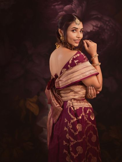 A stunning back-shot of Sapthami, showcasing an elegant and unconventional drape of the Banarasi saree.