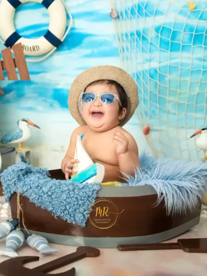 A fun-filled "Beach Baby" themed shoot for a first birthday. This little one is all smiles with his cool sunglasses, ready for a day of pretend sun and sand in the studio.