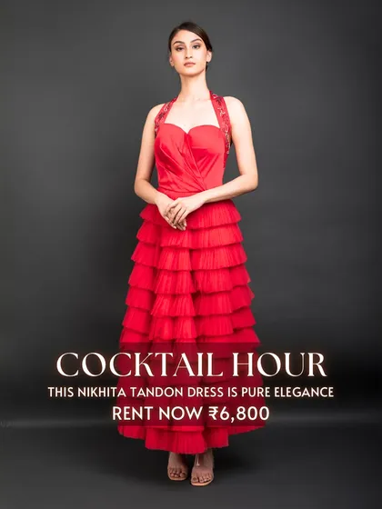 The 'Cocktail Hour' calls for pure elegance, like this red tiered dress by Nikhita Tandon. Its vibrant color and flattering silhouette make it a perfect rental for a glamorous evening party.