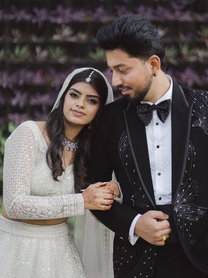 A classic portrait of the couple. The bride rests her head on the groom's shoulder, a simple yet powerful gesture of their bond.
