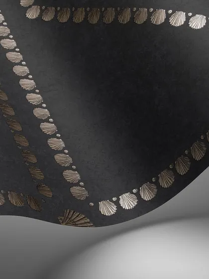 A swatch of the Conchiglie wallpaper in a dramatic black colorway. The metallic shells create a striking contrast, highlighting the geometric precision and intricate detail of the design.