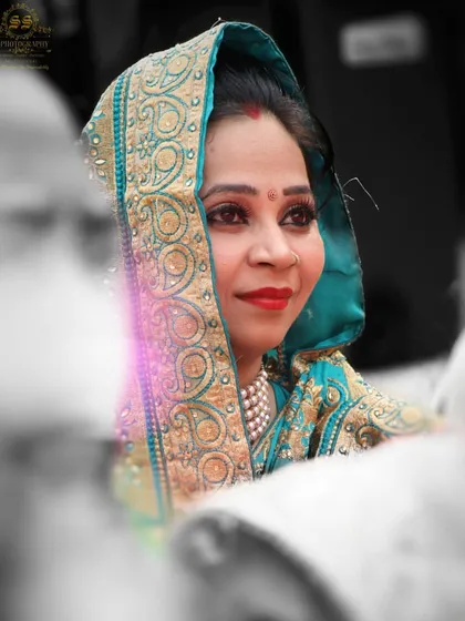 A candid shot of a wedding guest enjoying the ceremony. We believe in capturing the atmosphere of the day, which includes the happy faces of your family and friends.