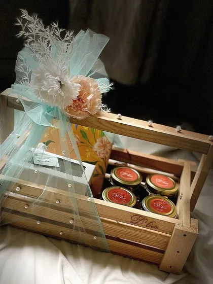 Our Luxury Rakhi Hamper, presented in a beautiful wooden crate, is filled with an assortment of truffles, brownies, cookies, and choco almonds.