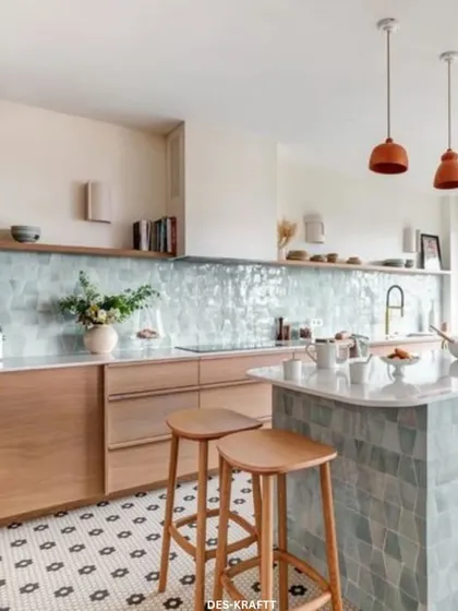 We believe a kitchen should be both beautiful and highly functional. This modern kitchen design features a stunning pastel blue tile backsplash, a versatile island with bar seating, and natural wood cabinetry, creating a bright and airy atmosphere for cooking and gathering.